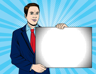 Vector colorful pop art style illustration of a young businessman showing a big white card. Happy handsome guy in suit with big board.