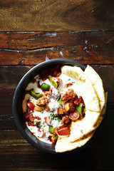 Tortilla with chili pork and sour cream sauce 