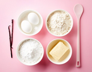 Fototapeta na wymiar Baking ingredients on pink, from above