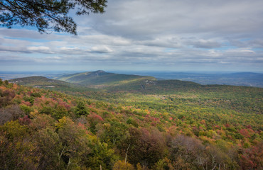 Overlooking the Shawangunk Mountain Range surrounded by bright fall foliage on a partly cloudy afternoon at Minnewaska State Park, Kerhonksen, NY