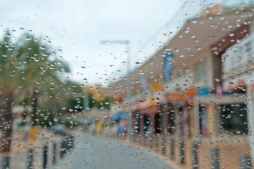 Raindrops on car window along closed bars in Cala Estancia