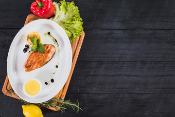 Fried salmon steak with lemon sauce