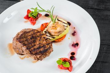 Grilled meat steak dish with fruits garnish