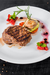 Grilled meat steak dish with fruits garnish
