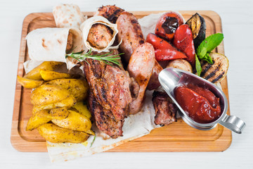 Grilled sausage dish with vegetable garnish. Top view