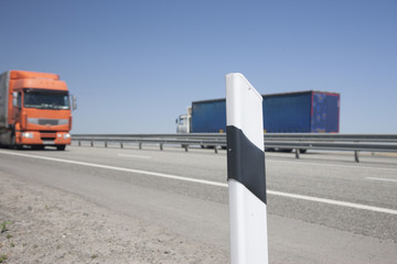 Fencing of the highway On a blurred background cars