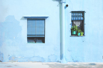 Blue facade of a Mediterranean village in Spain. Tourism background and empty copy space for Editor's text.