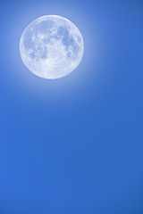 Full Moon on blue twilight sky