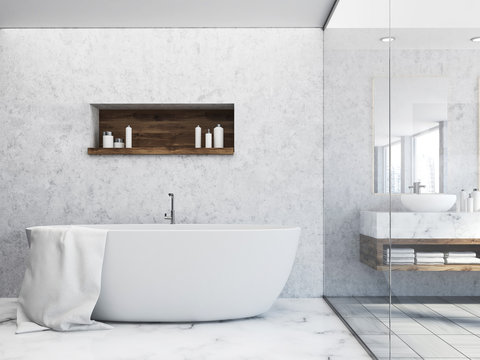 White tub in a concrete wall bathroom
