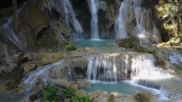 Picturesque Kuang Si waterfall in Loas. Water falling from rocks. Drone shot.