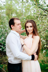 Fototapeta premium a young couple in love in the spring flowering Park