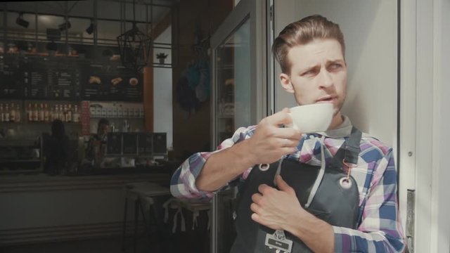 Cute Barista Drinks Coffee Early In The Morning On The Porch Cafe