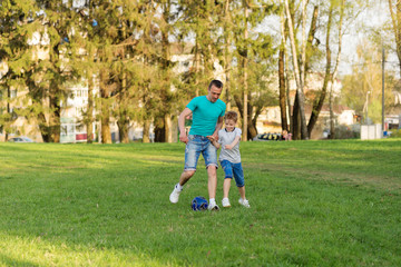 Family playing football on the field. Family football