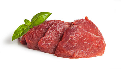 Raw beef meat piece and slices, with basil isolated on white background. 