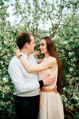Fototapeta premium a young couple in love in the spring flowering Park