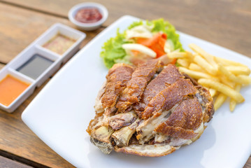 German pork knuckle hocks or Gebratene Schweinehaxe with several sauces and fried potatoes delicious Thai food.