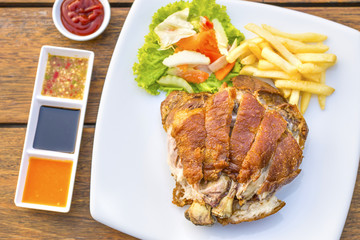 German pork knuckle hocks or Gebratene Schweinehaxe with several sauces and fried potatoes delicious Thai food.