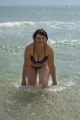 a woman plays water in the sea