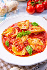 Delicious pasta - ravioli in tomato sauce with basil
