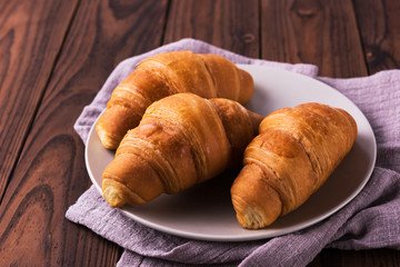 Freshly baked butter croissant. Closeup