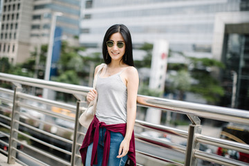 Summer sunny lifestyle fashion portrait of young stylish hipster woman walking on the street,...