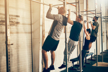 People doing chin ups together during a gym workout session