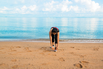 Woman stretching on the beach.