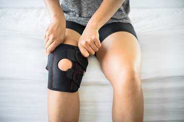 Women use knee supporter to prevent injuries. - obrazy, fototapety, plakaty