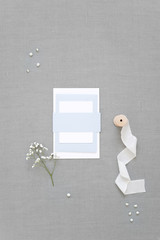 Feminine wedding, birthday desktop mock up. Blank greeting cards, envelope. Grey table background. Flat lay, top view.