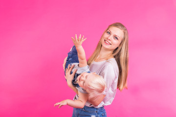 mother and daughter having fun isolated on pink background