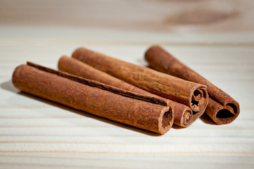Sticks of fragrant cinnamon shot against the background of a wooden surface