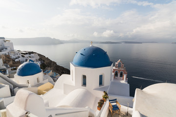 Traditional Orthodox blue dome church in Greece on a very sunny summer day, with the typical blue and white colours. Santorini, Cyclades Islands, Greece, Europe