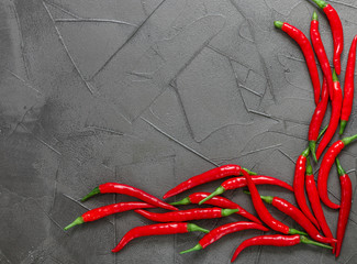 Red hot pepper pods close up on black background