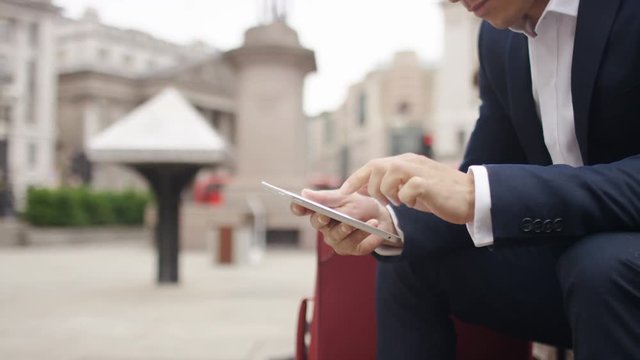 Smart asian man in the city using a digital tablet