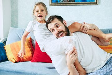 Father and his six years kid girl at home