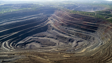 Aerial view of opencast mining quarry with lots of machinery at work. Mining-dressing quarry - 209369003