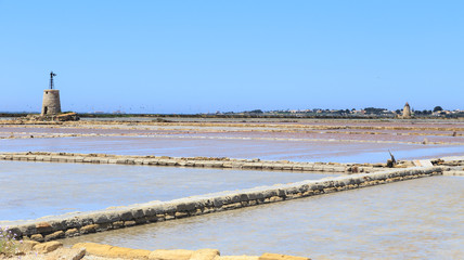 Windmills raising water and flats in which water is evaporated to obtain salt in salines near...