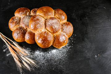 Sweet buns on black wooden background