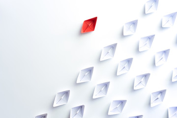 Group of paper ship in one direction and with one individual is different. Business for Innovative...