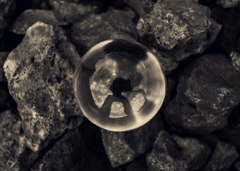 Reflections of the photographer in glass ball