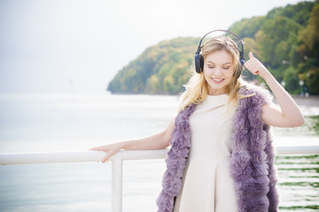 Happy woman wearing headphones outdoor