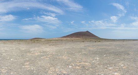 Fototapeta na wymiar Panoramic view of the Red Mountain (Montana Roja) and El Medano beach on Tenerife, Canary Islands