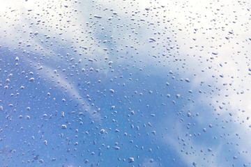 Raindrops on the blue surface of the metal texture, sky arrangement, glitter