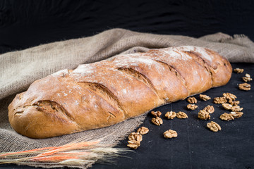 Dietic bread with nuts on wooden background