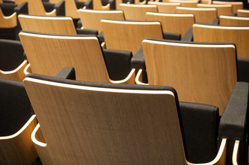closeup of wooden seat alignment  in auditorium