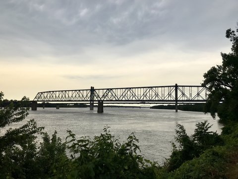 Sunset behind truss bridge over Mississippi River