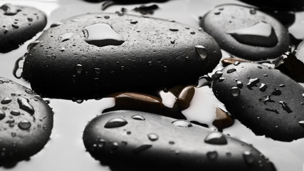 Black wet pebbles background