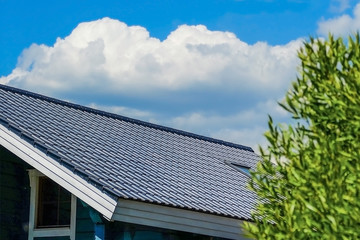 Fototapeta premium Tile is a building materials used for the roof of the house. Against the sky.