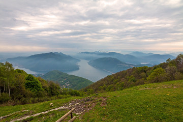 Balcony of Italy - Panorama of Lake Lugano in cloudy day. Alps with Mount blanc in background. Lombardia, Italy