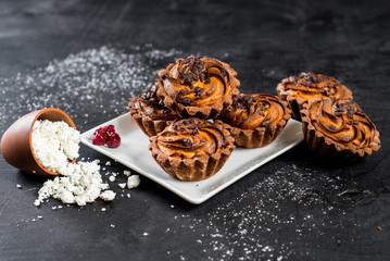 Sweet cupcakes with a cottage cheese on black background